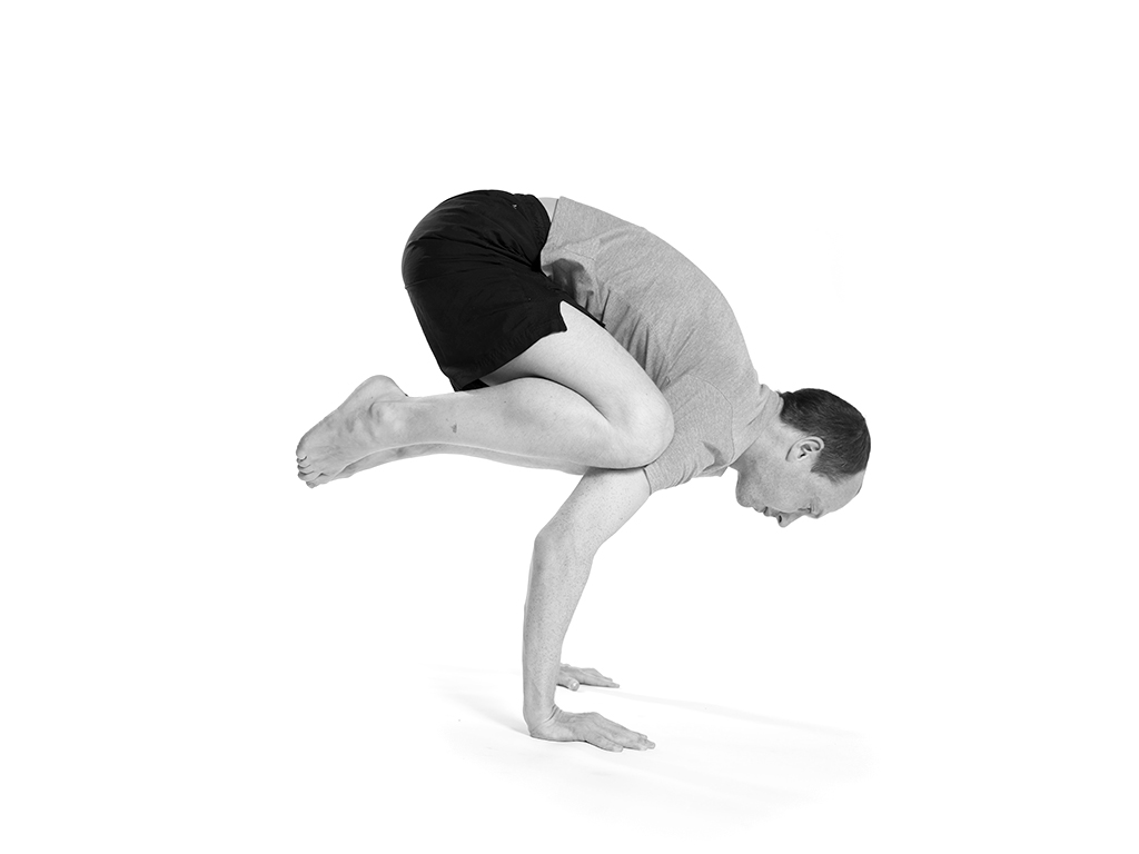 Student practicing bakasana