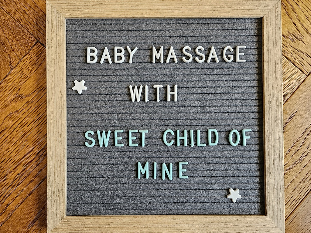 Pin board letters spelling out baby massage