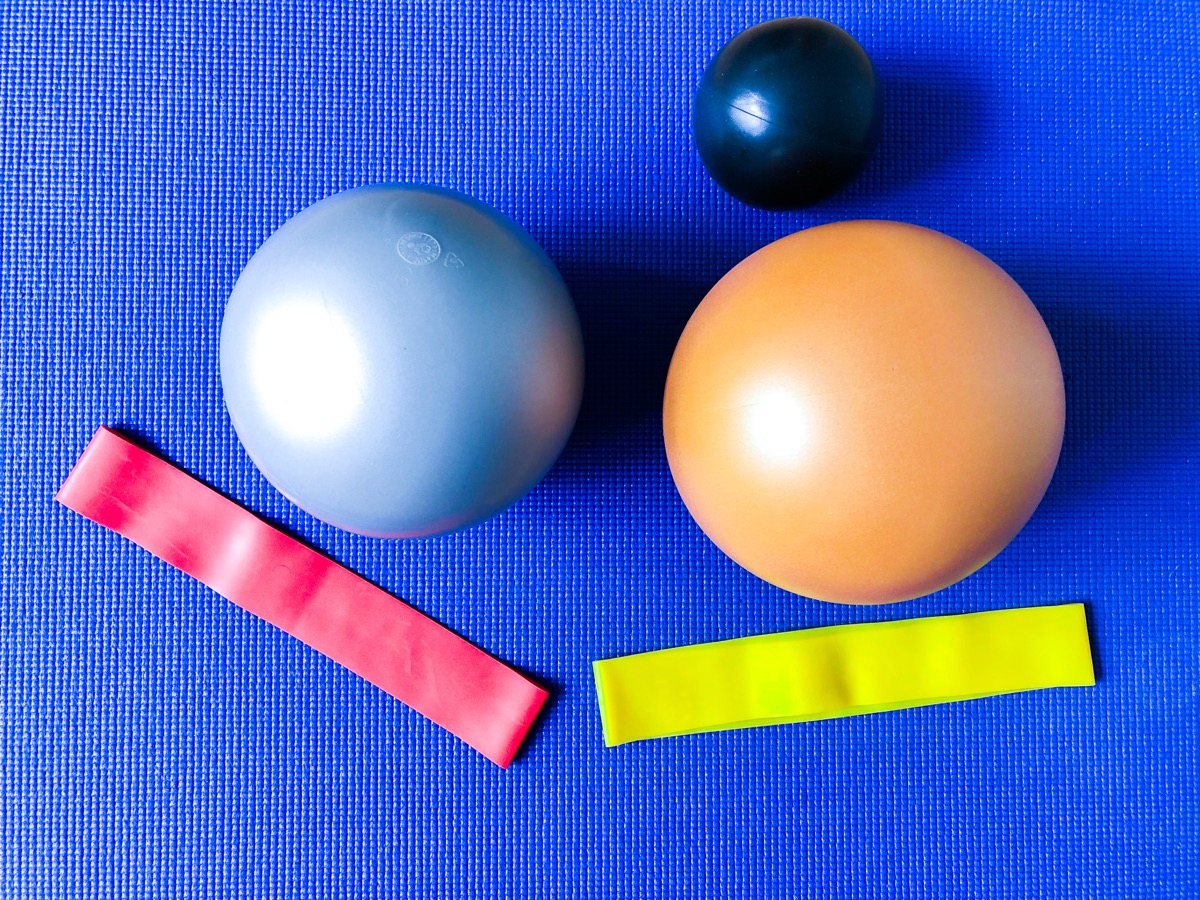 Exercise balls and bands on a yoga mat